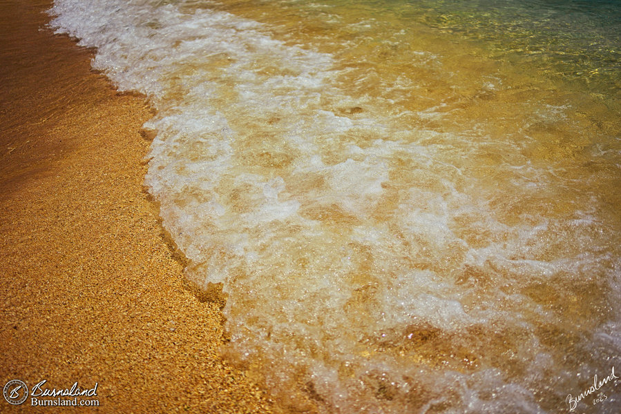 Waves and sand on the shore in George Town, Grand Cayaman
