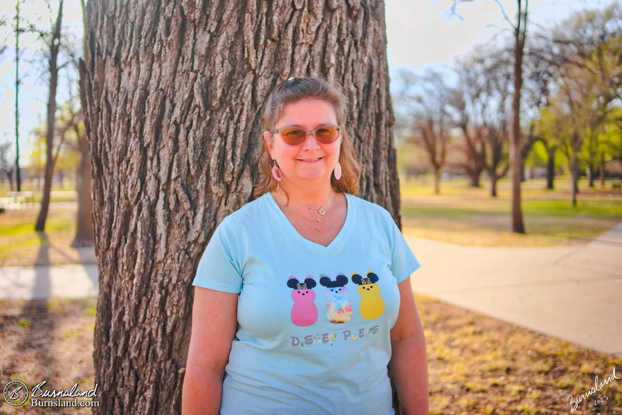 Laura in her Disney Peeps Easter shirt under a tree in Wichita, Kansas