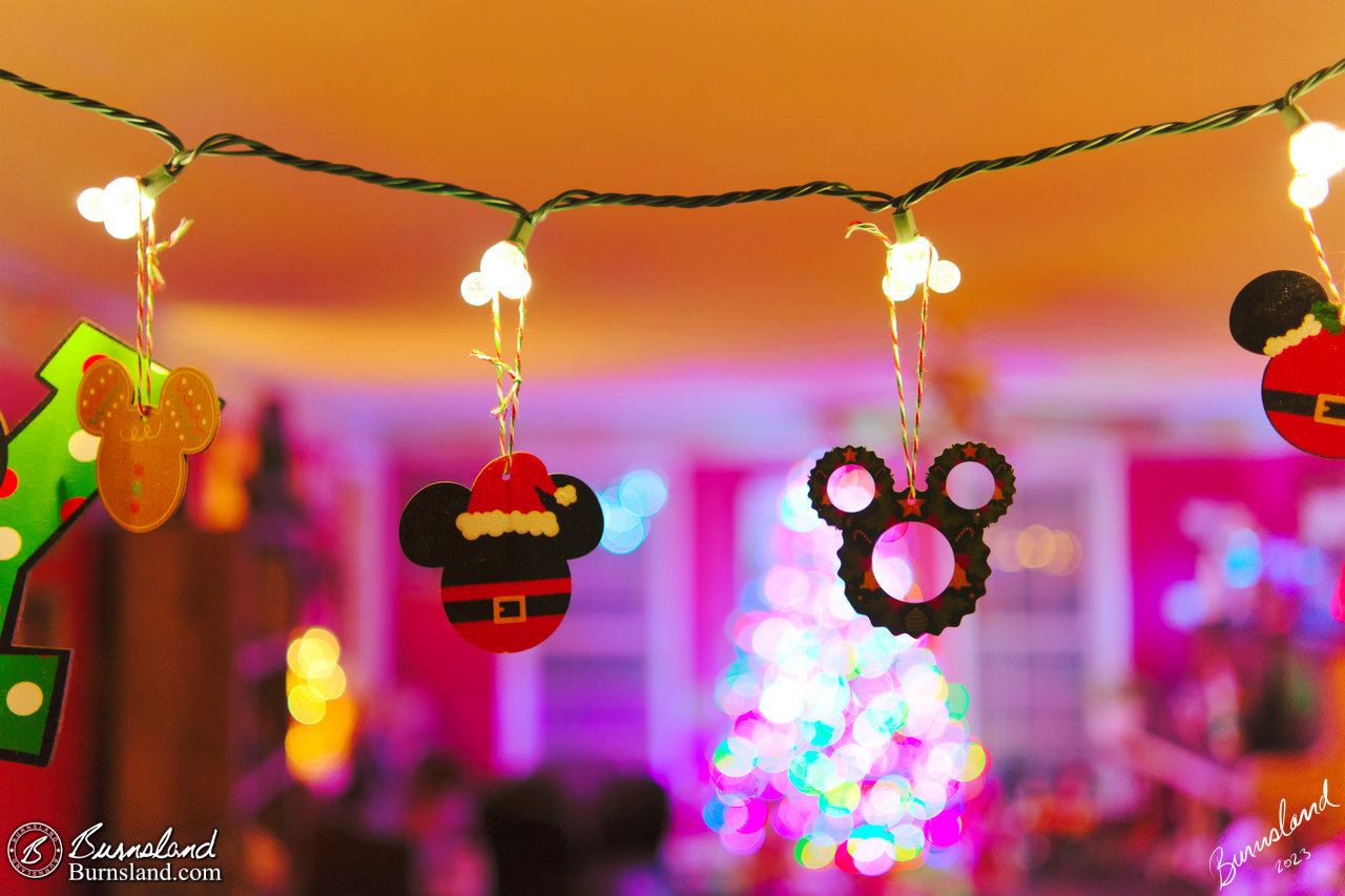 Mickey Mouse shaped Christmas ornaments hang from Mickey Mouse lights in a doorway in our house for the 2023 Christmas Season