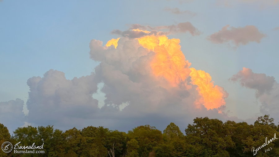 Sunlight on the tops of a tall cloud formation